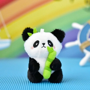 Close-up view of cute panda plush doll keychain holding a green bamboo stick.
