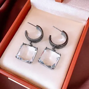Vintage C-shaped square glass earrings with textured gunmetal finish on orange gift box