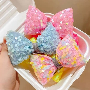 Sparkly sequin mermaid bow hair clips in pink blue and rainbow colors for girls