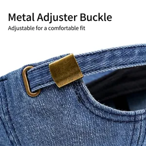 Adjustable back strap on a vintage washed denim baseball cap with metal buckle closure