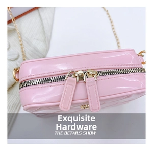 Detailed macro view of pink PVC jelly bag showing gold double zippers and quilted texture