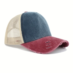 Close-up of distressed red brim and mesh back detail on washed denim baseball cap