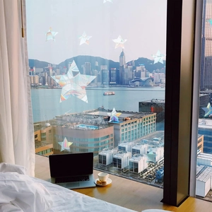 Rainbow prism holographic star window stickers reflecting colorful light in a sunlit room
