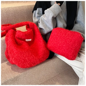Detailed macro view of bright red faux fur tote bag and matching zipper clutch set