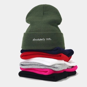 Stack of ribbed knit beanies in multiple colors with 'absolutely not' letter embroidery