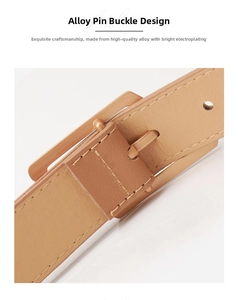 Detail of light khaki leather belt featuring a matte alloy buckle and precise stitching