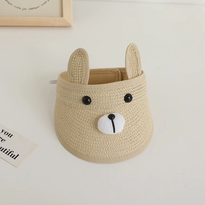 Top view of beige straw sun visor for kids with cute cartoon bear ears and face details
