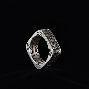 Vintage square silver ring for men with intricate Celtic knot patterns on a black background