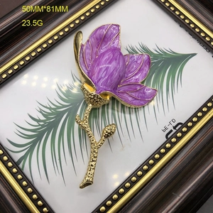 Detailed macro view of purple enamel magnolia brooch with golden stem, size 50mm by 81mm