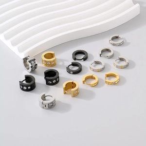 Close-up of C-shaped titanium steel hoop earrings with white zircon in gold and silver