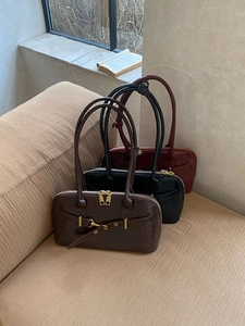 Detailed row of vintage leather bowling bags in dark brown, black, and wine red colors
