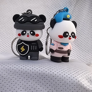 Close-up of cute silicone panda keychains in police and tactical swat uniforms