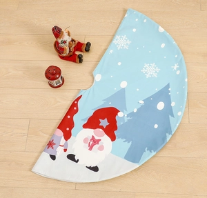 Light blue Christmas tree skirt with gnome prints and snowflakes on wooden floor