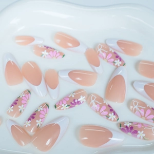 French almond press-on nails with white tips, daisy floral patterns, and bow designs