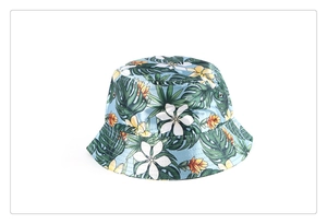 Detail of floral printed bucket hat with tropical leaf patterns and metal ventilation eyelets