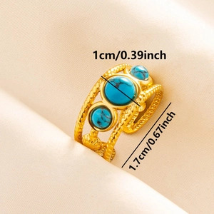 Detailed macro view of retro gold ring with turquoise stones and braided open band
