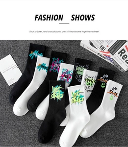 Flat lay view of street style graffiti socks in black and white with punk knit texture