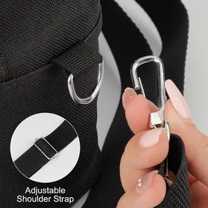 Black canvas makeup bag with adjustable shoulder strap and silver metal D-rings