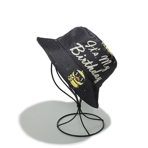 Detailed side view of black bucket hat featuring 'It's My Birthday' text and duck