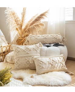 Detailed close-up of bohemian cushion covers with tufted textures and decorative tassels