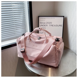 Pink waterproof yoga bag on metal table with adjustable straps and side zipper pocket
