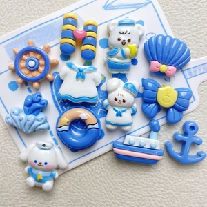 Flat lay of resin nautical DIY accessories with anchor, boat, and sailor bear icons