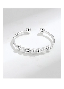 Macro shot of S925 sterling silver beads with polished and frosted textures on a ring