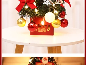 Detail of mini Christmas tree with warm LED lights, red bows and gold ornaments