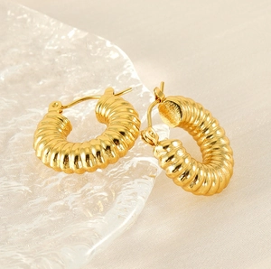 Close-up of 18K gold plated stainless steel hoop earrings with textured ribbed design