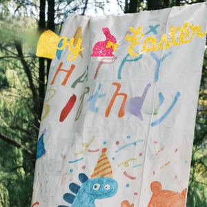Close-up of glittery Happy Easter banner with pink bunny and golden hanging letters