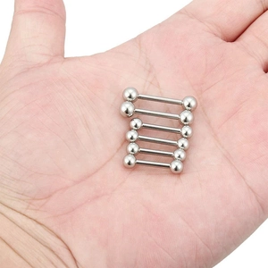 Close-up of six silver surgical steel tongue barbells held in palm showing scale