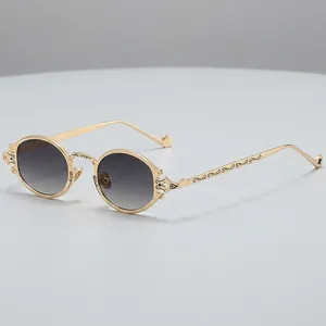 Vintage steampunk oval sunglasses with gold carved metal frame and dark lenses