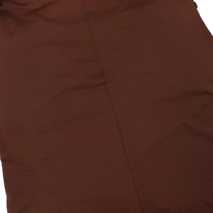 Close-up of deep brown textile fabric with detailed twill texture and vertical stitching seam