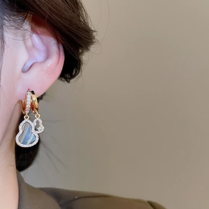 Detailed close-up of double gourd earrings with blue shell inlay and micro-pave crystals