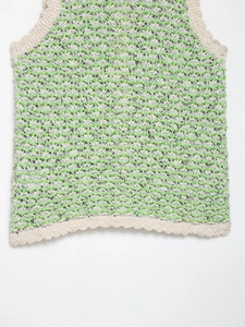 Detail of green and beige textured knit pattern on sleeveless cropped crochet top