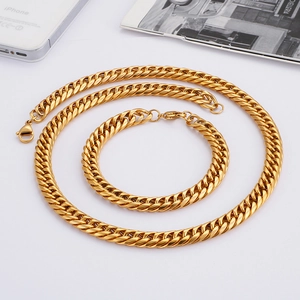 Detailed view of golden Cuban link necklace and bracelet set with lobster clasp