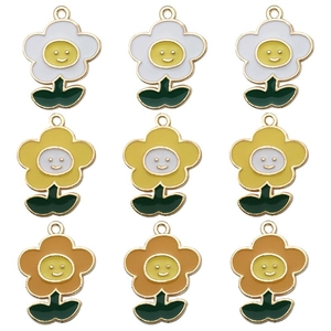Detail showing assorted colorful enamel sunflower pendants with smiley face center motifs