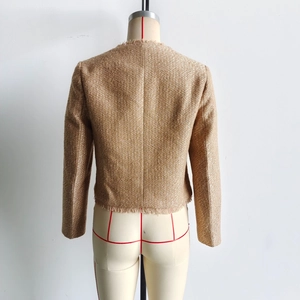 Rückansicht der goldenen Tweed-Kurzjacke mit Fransensaum und schimmerndem Strukturdetail