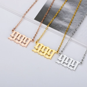 Detailed close-up of 999 angel number pendants in gold, rose gold and silver finishes