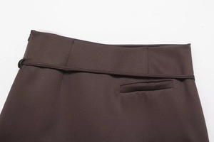 Detailed close-up of dark coffee belt and pocket stitching on high-density fabric skirt