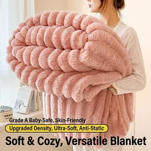 Pink wavy textured faux rabbit fur blanket held by model for cozy home warmth