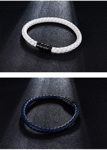 Detail of white and navy braided microfiber leather bracelets with black magnetic clasps