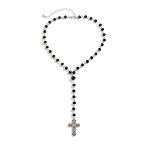 Close-up of gothic beaded necklace with vintage silver cross and heart engraving