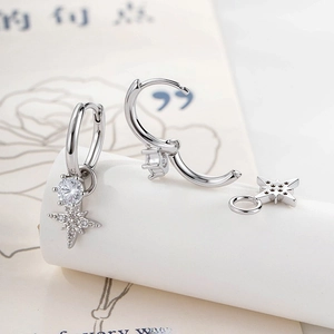 Silver hoop earrings with detachable micro-set zircon star pendants on white podium