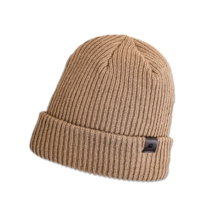 Detailed rib-knit texture of a brown winter beanie featuring a black leather logo patch
