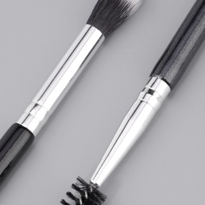 Detail of dual-ended eyebrow brush with spiral spoolie and fine synthetic bristles