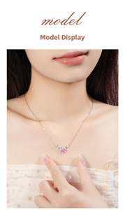 Detail of 925 silver rose gold necklace with double hearts and pink gemstone