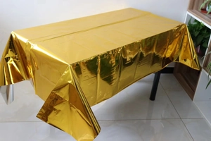 Metallic rose gold disposable tablecloth showing reflective foil texture on rectangular table