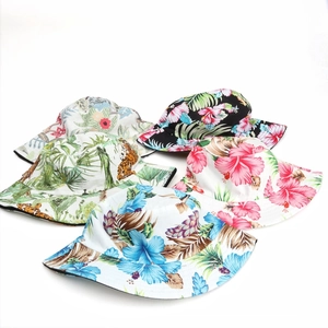 Flat lay of bucket hats featuring diverse floral, tropical, and leopard prints