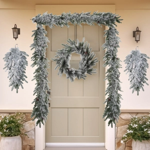Detailed set of flocked Christmas garland and wreath with pine cones on a decorated porch